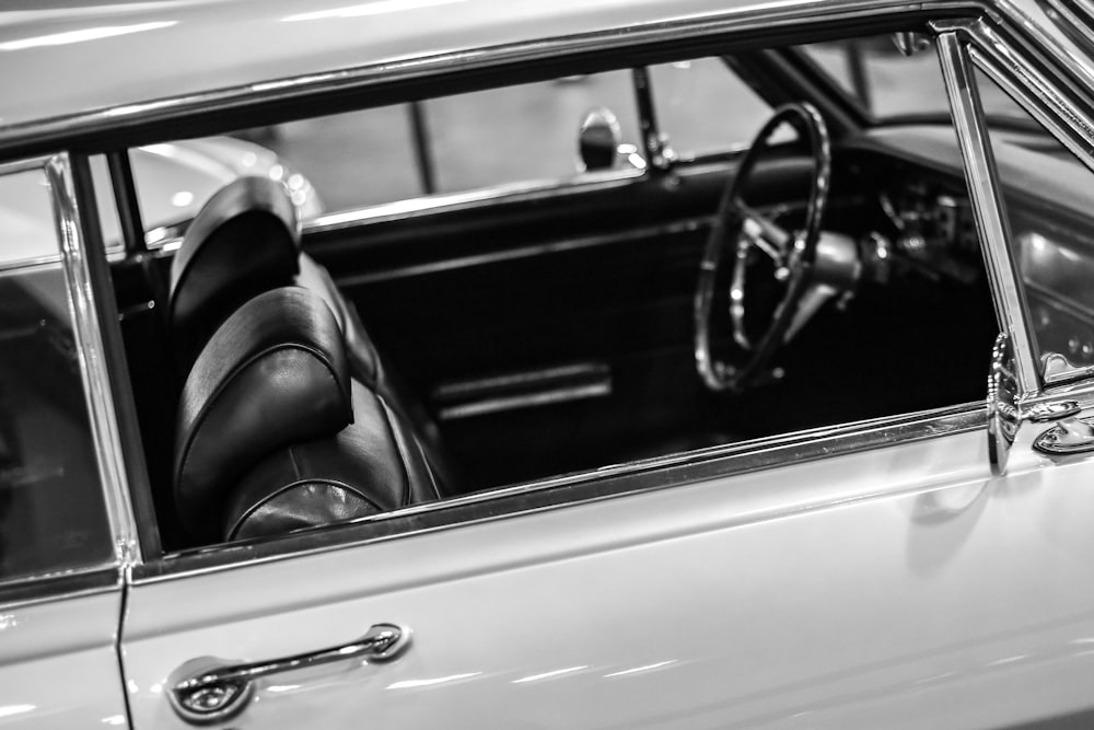 a black and white photo of a car's interior