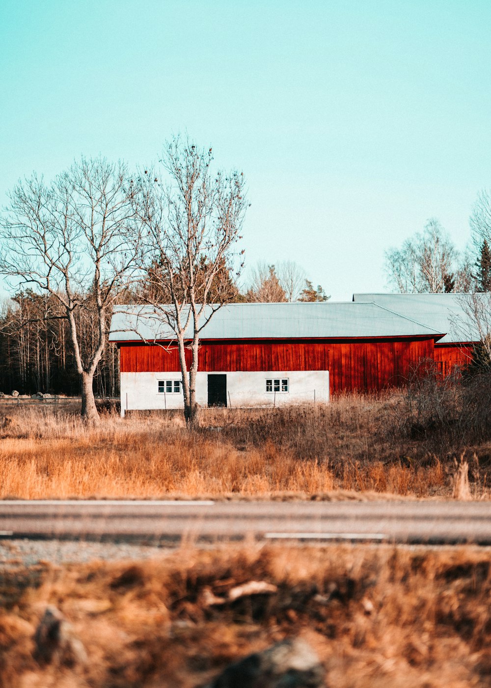 a red and white barn sitting in a field