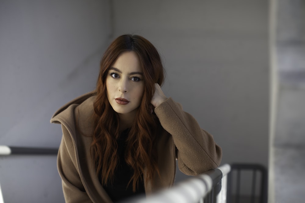 a woman with red hair is sitting down