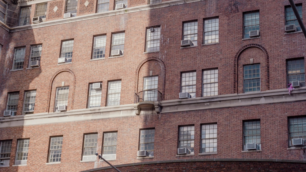 a large brick building with a clock on the front of it