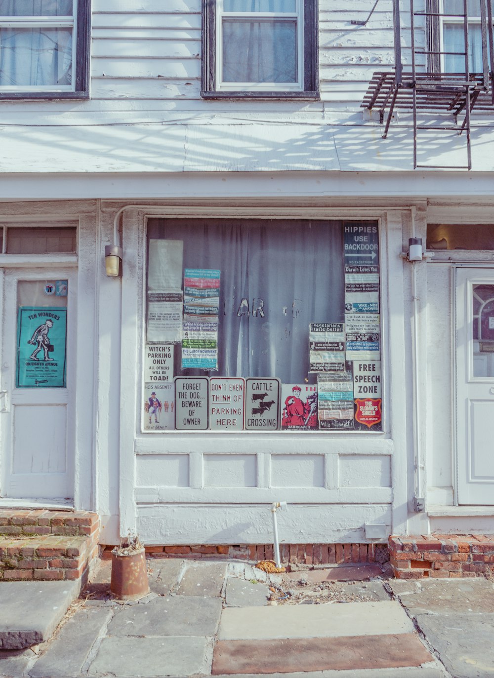 a store front with a bunch of signs in the window