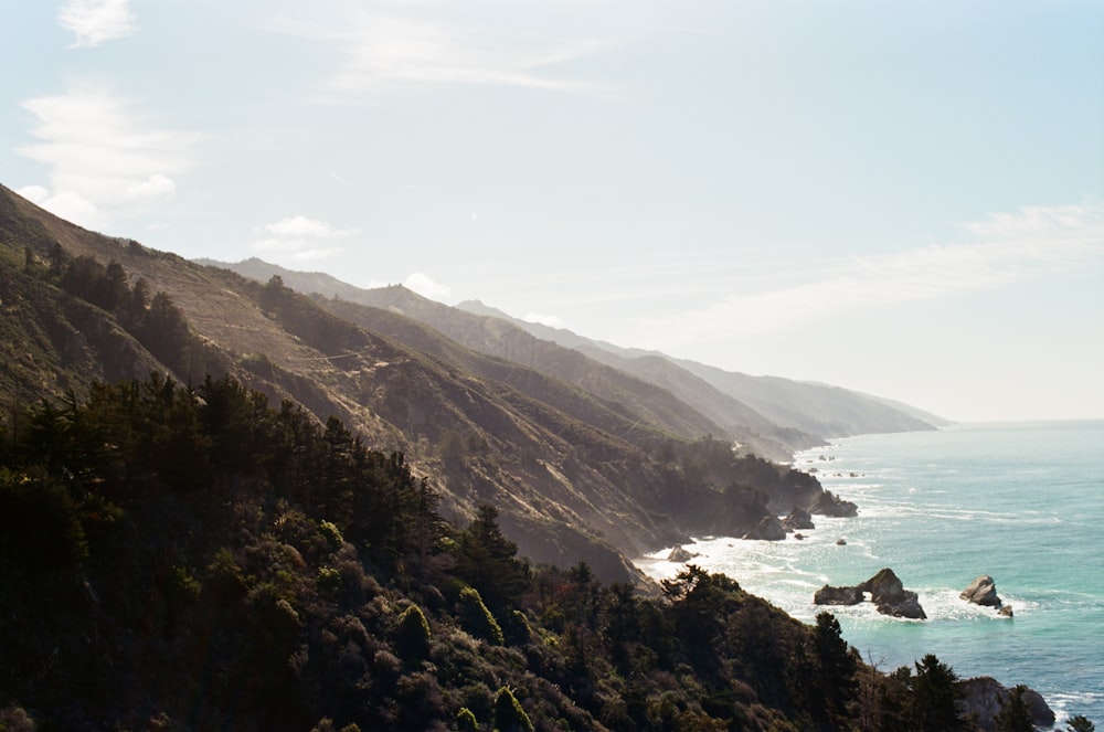 a scenic view of the ocean and mountains