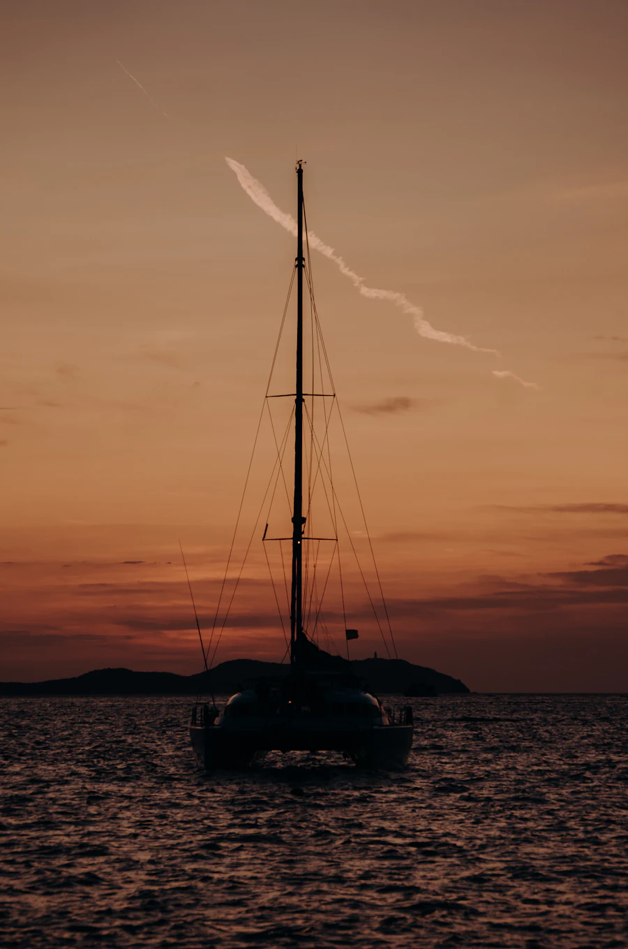 Sailboat at sunset on calm water