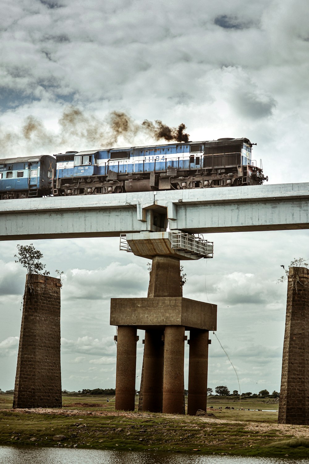 a train traveling over a bridge over a river