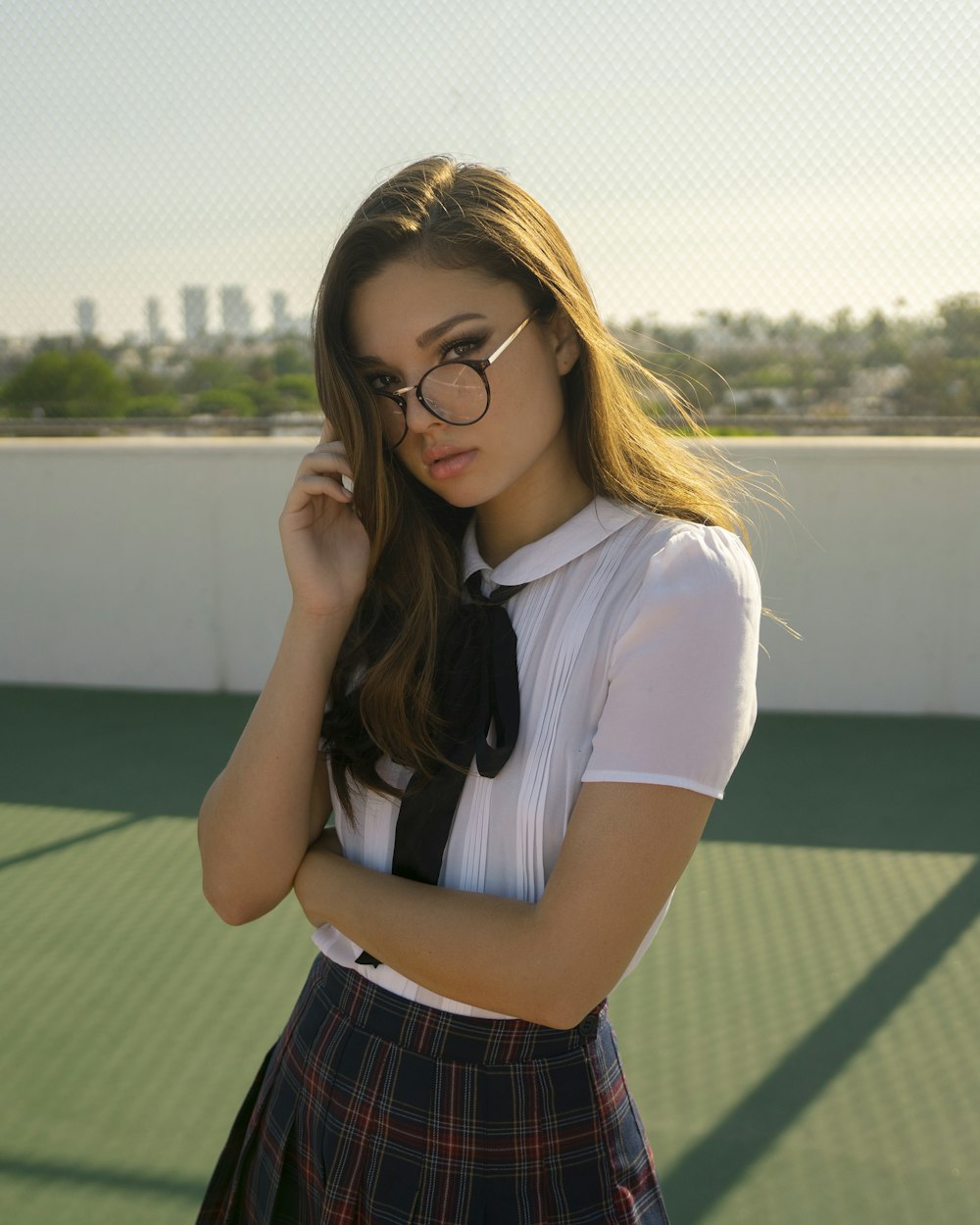 a girl in a school uniform is posing for a picture