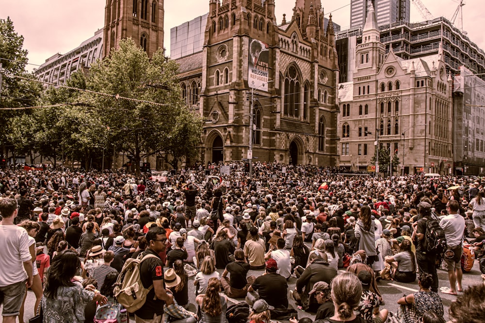 a large group of people standing in front of a building