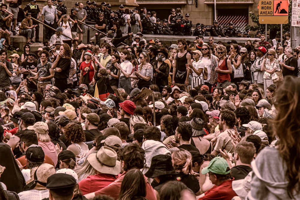 a crowd of people standing around each other