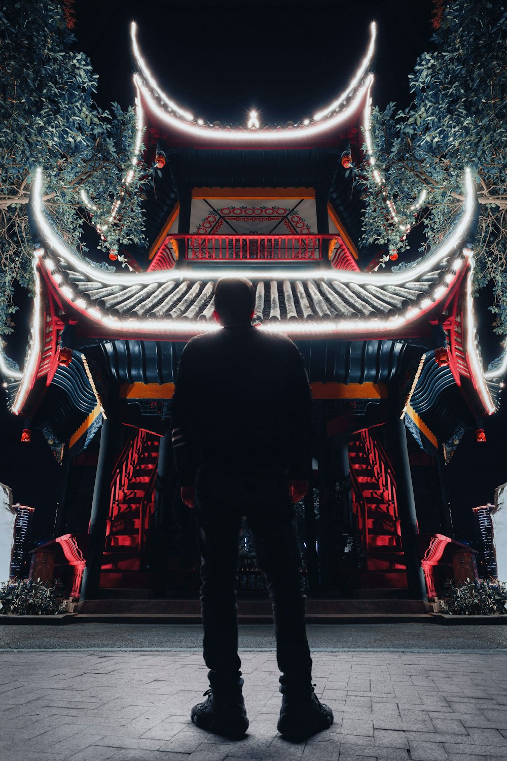 a man standing in front of a tall building