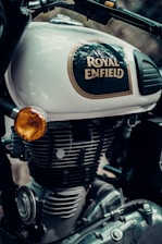 Close-up of a Royal Enfield motorcycle receiving an oil change with genuine parts visible.