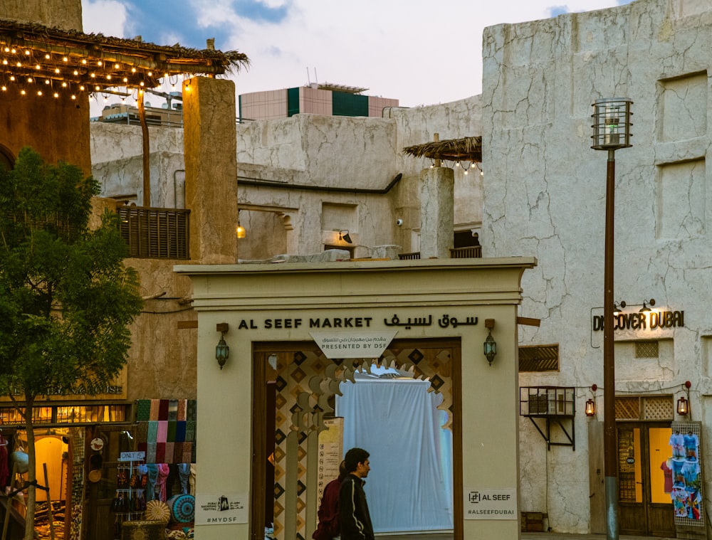 a man walking through a doorway of a market