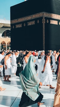 a group of people walking around a large building