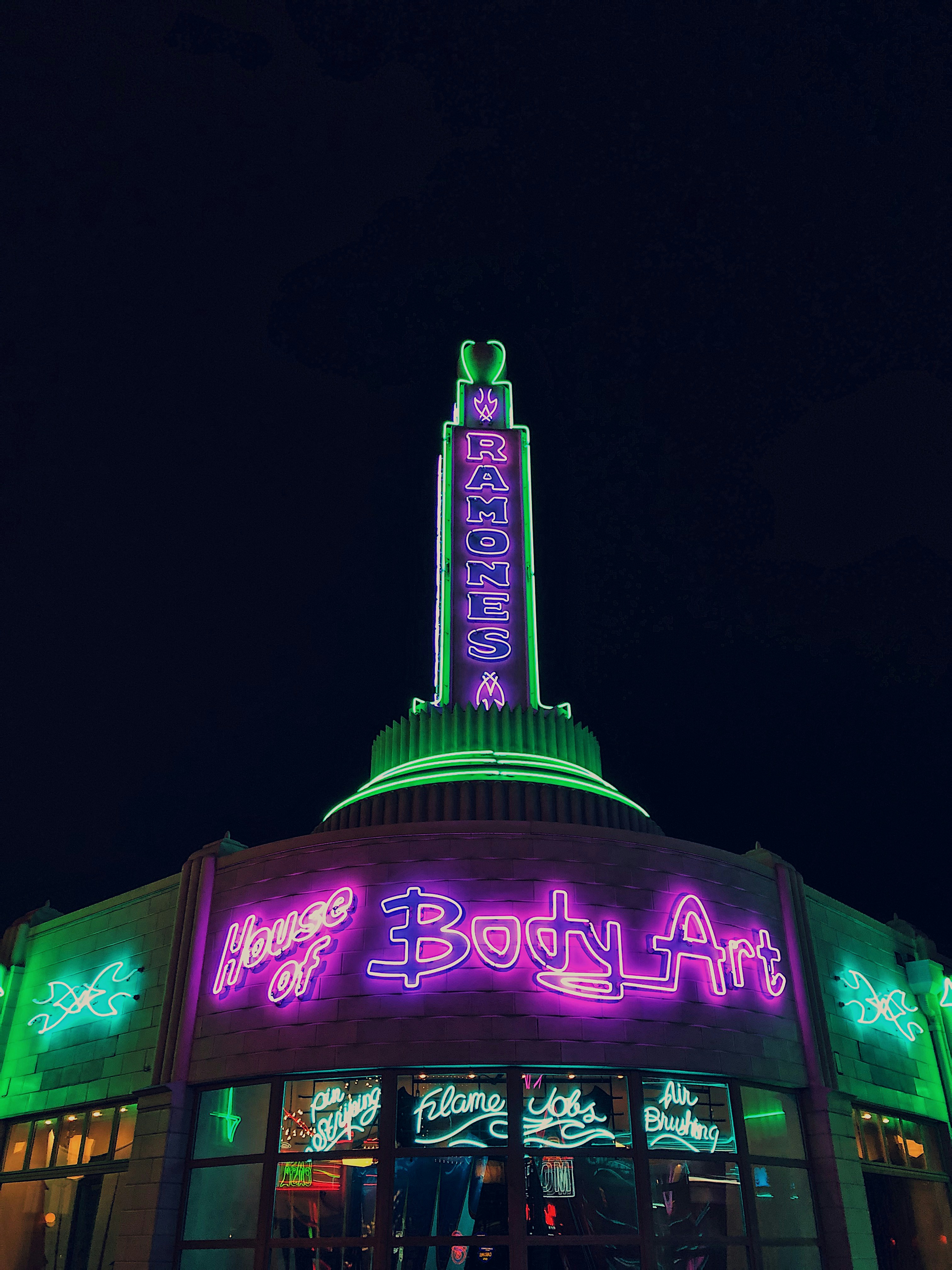 purple and green led signage