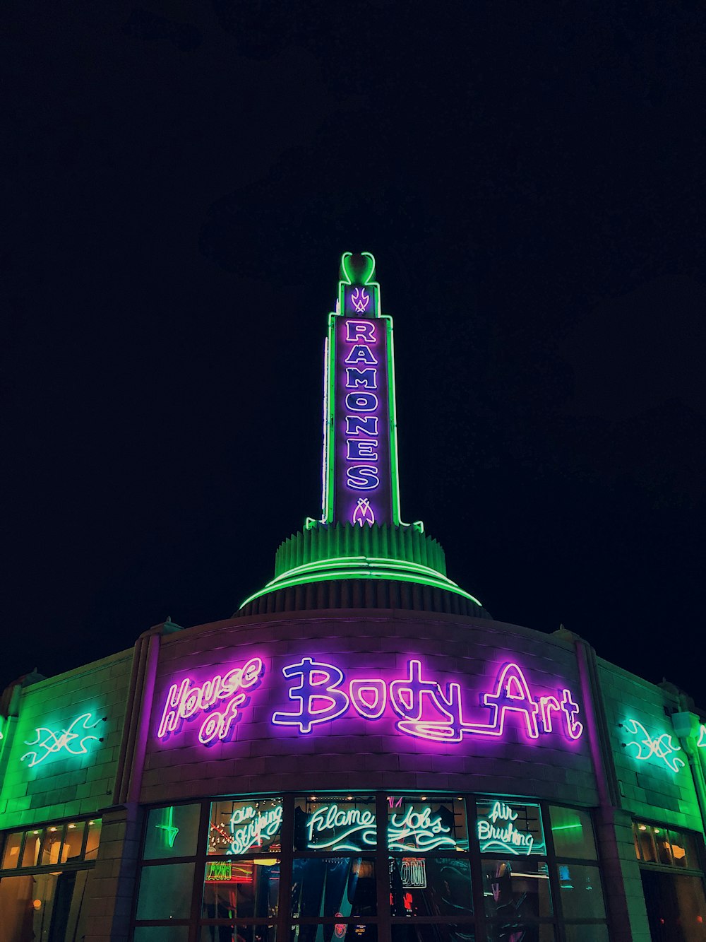 purple and green led signage