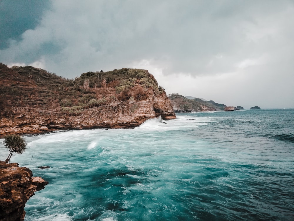 a body of water near a rocky shore