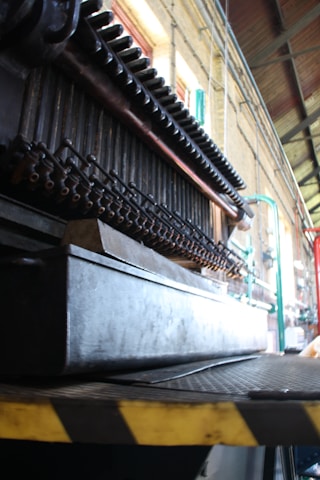 Technician inspecting a complex conveyor system in an industrial setting.