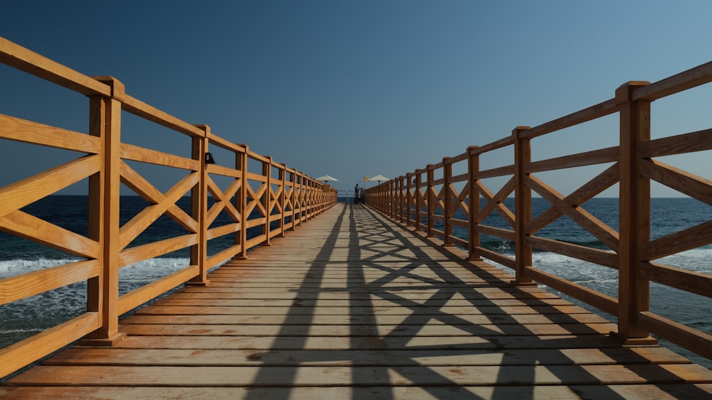 brown wooden bridge under blue sky during daytime