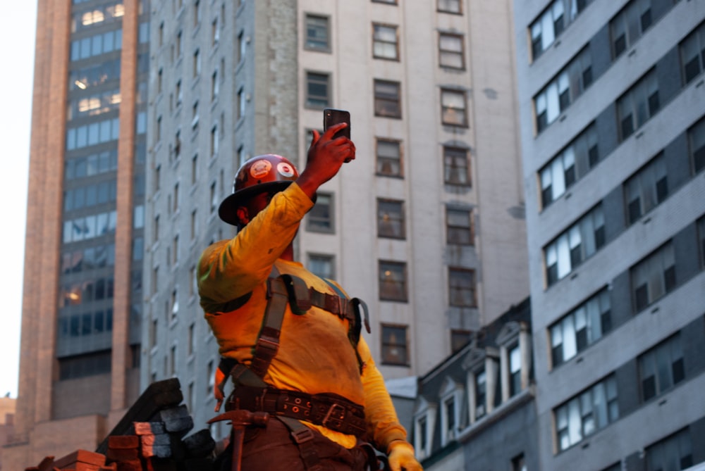 a man dressed as a construction worker taking a selfie
