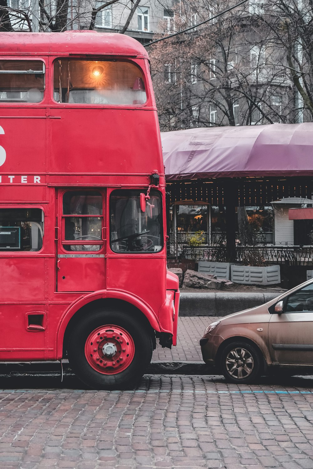 red double decker bus on road during daytime