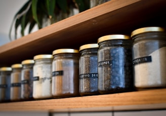 a shelf filled with lots of different types of spices