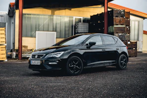 black bmw m 3 parked near white building