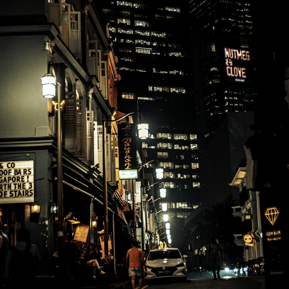 people walking on street during night time