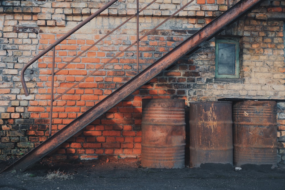 brown brick wall with black metal staircase