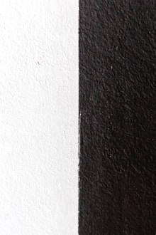 black textile beside white wall