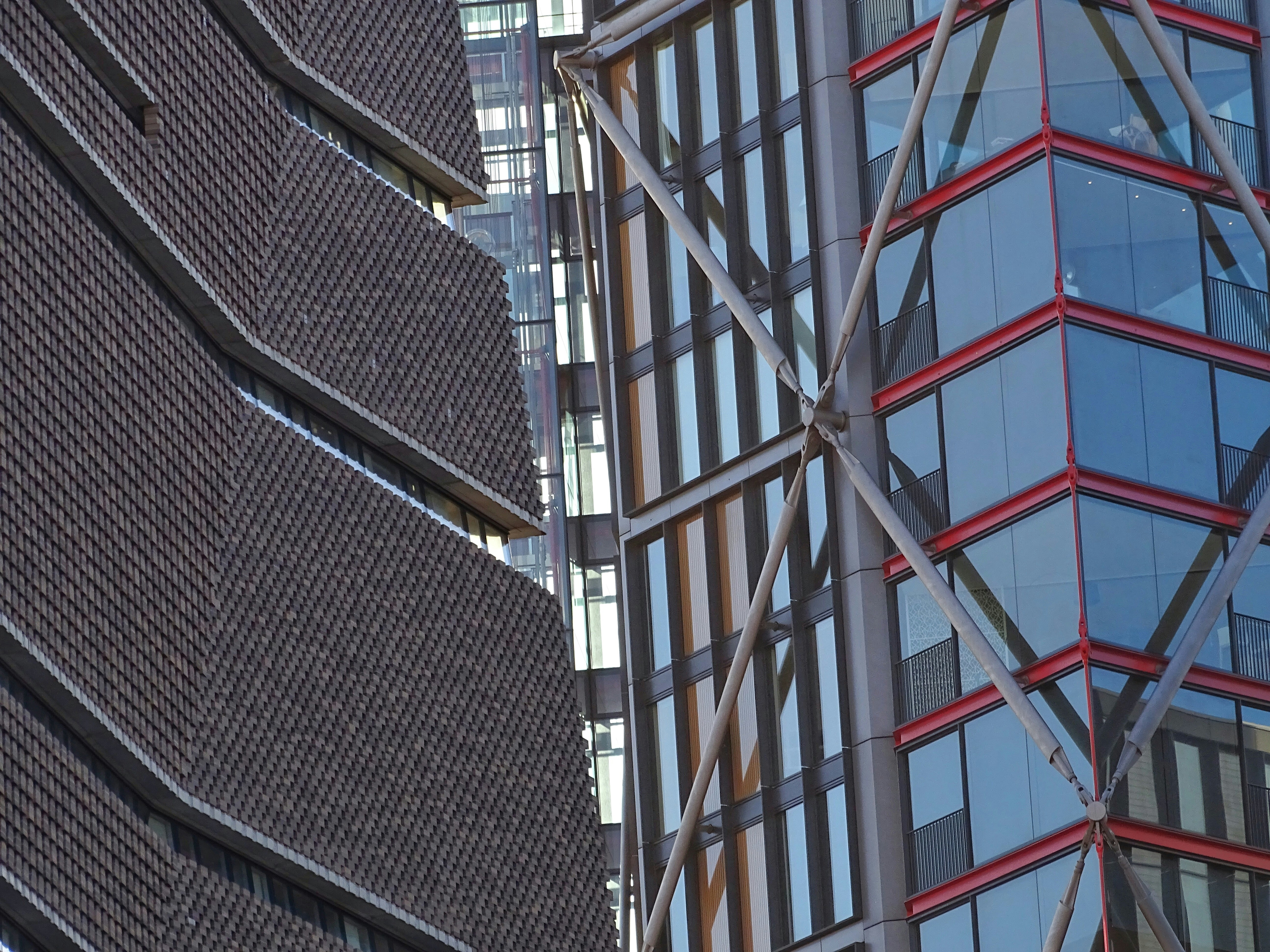 Modern building exterior with mixed facade cladding systems including metal and composite panels