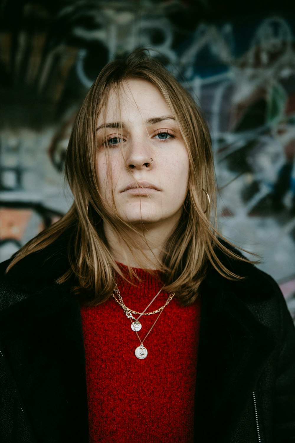 woman in black jacket and red turtle neck shirt