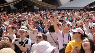 A diverse group of people using mobile devices outdoors.