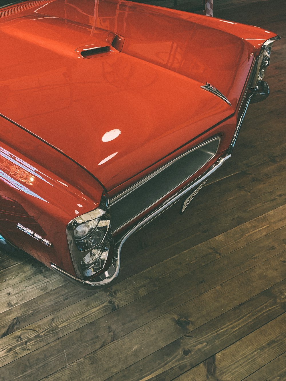 orange car on brown wooden floor