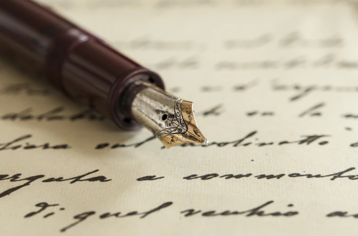 Fountain pen marking up a draft by-law