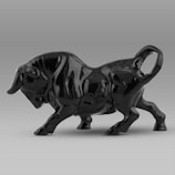 A black bull statue placed on a wooden table symbolizing strength and simplicity.