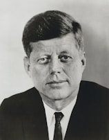 A polished, modern LinkedIn headshot of a professional in business attire with a clean, neutral background.