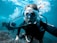 person in black and white diving suit wearing goggles
