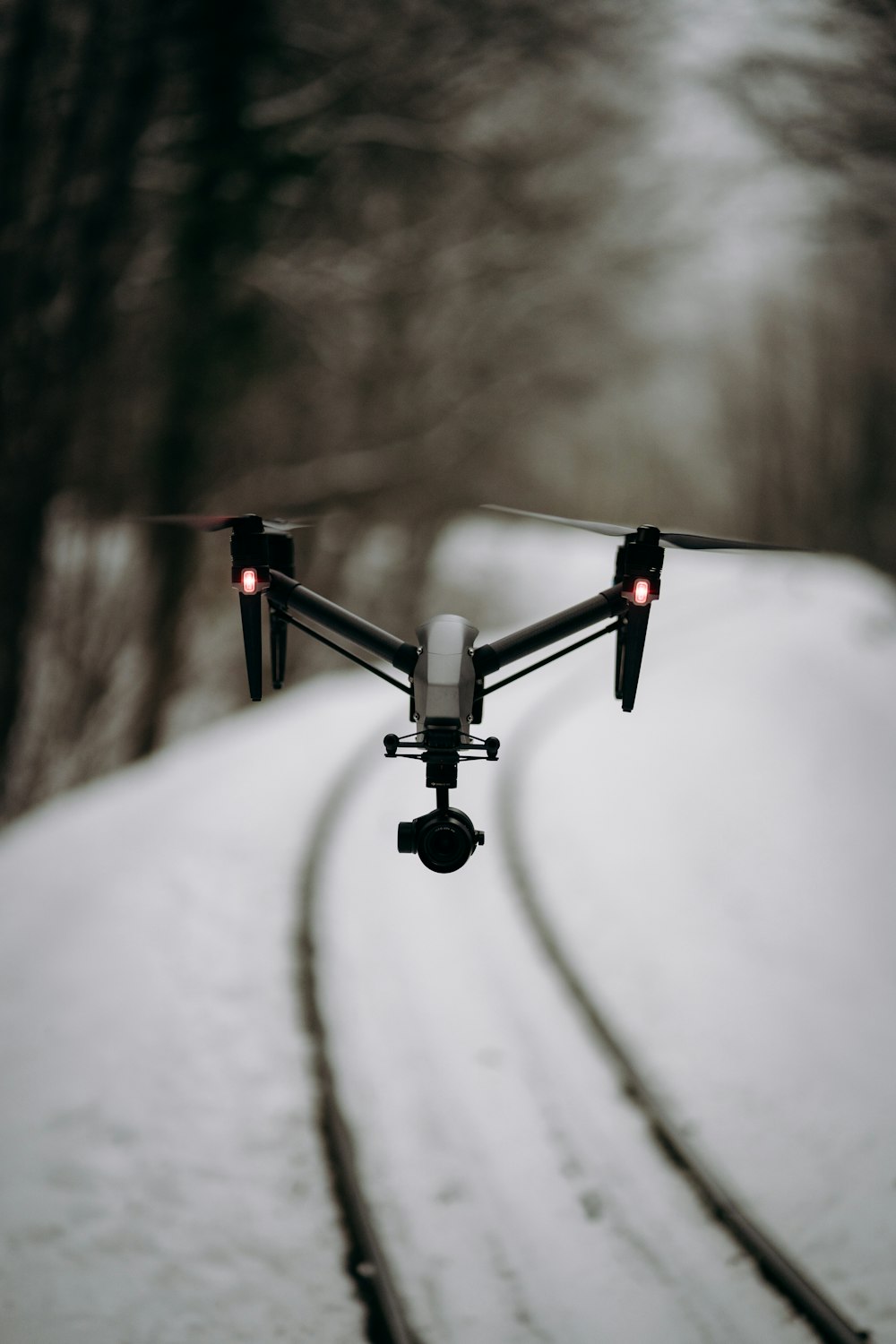 black and white drone flying on the sky during daytime