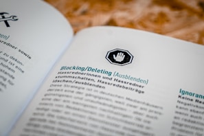 A document open to a page in German, featuring headings and text about blocking or deleting content, with an icon of a hand in a stop sign above the heading.