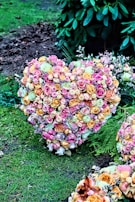 A heart-shaped arrangement of flowers on a table.