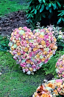 A heart-shaped arrangement of flowers on a table.
