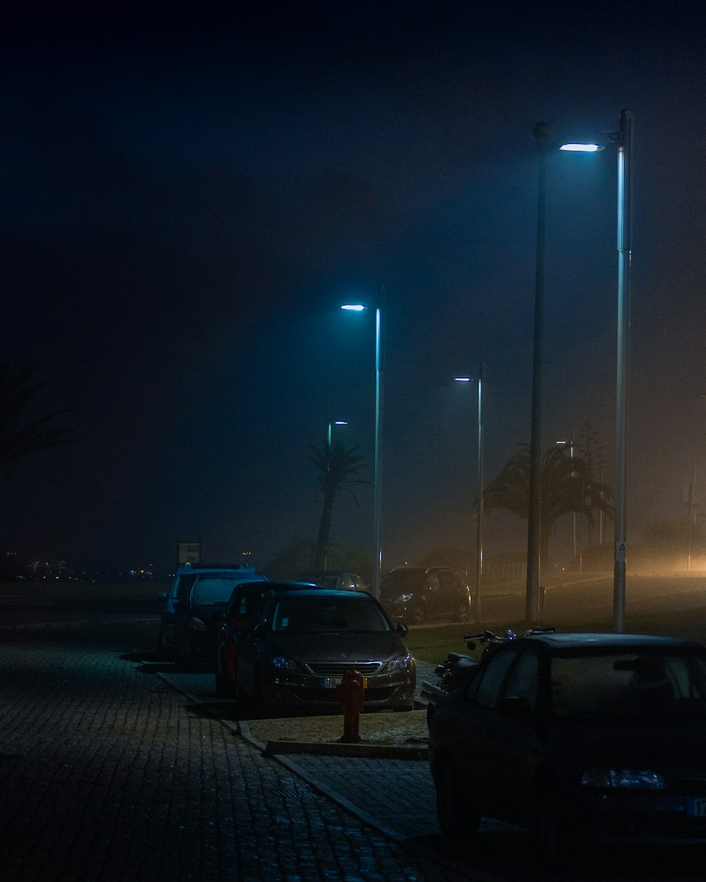 a car parked on the side of a road at night