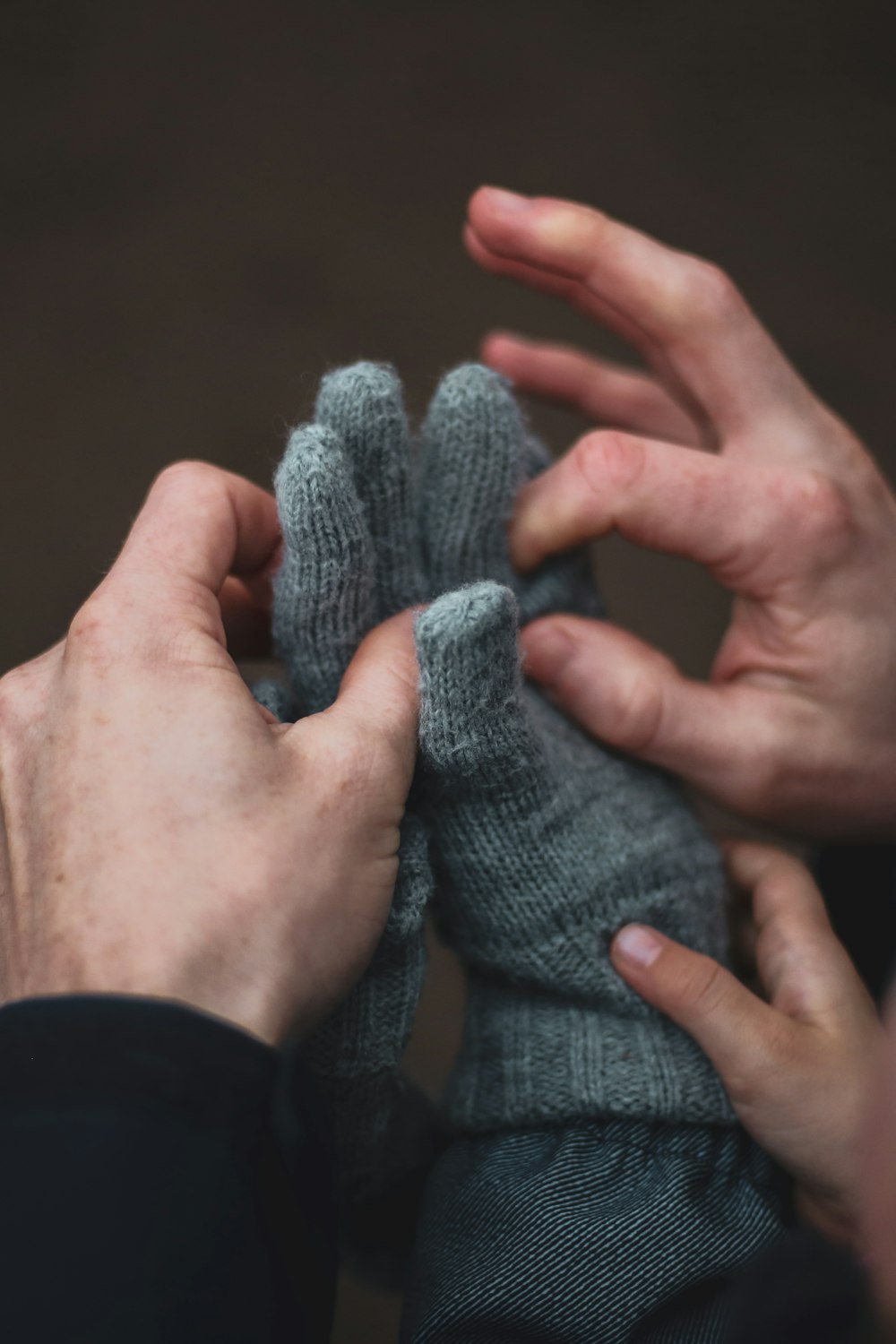 person holding gray knit gloves