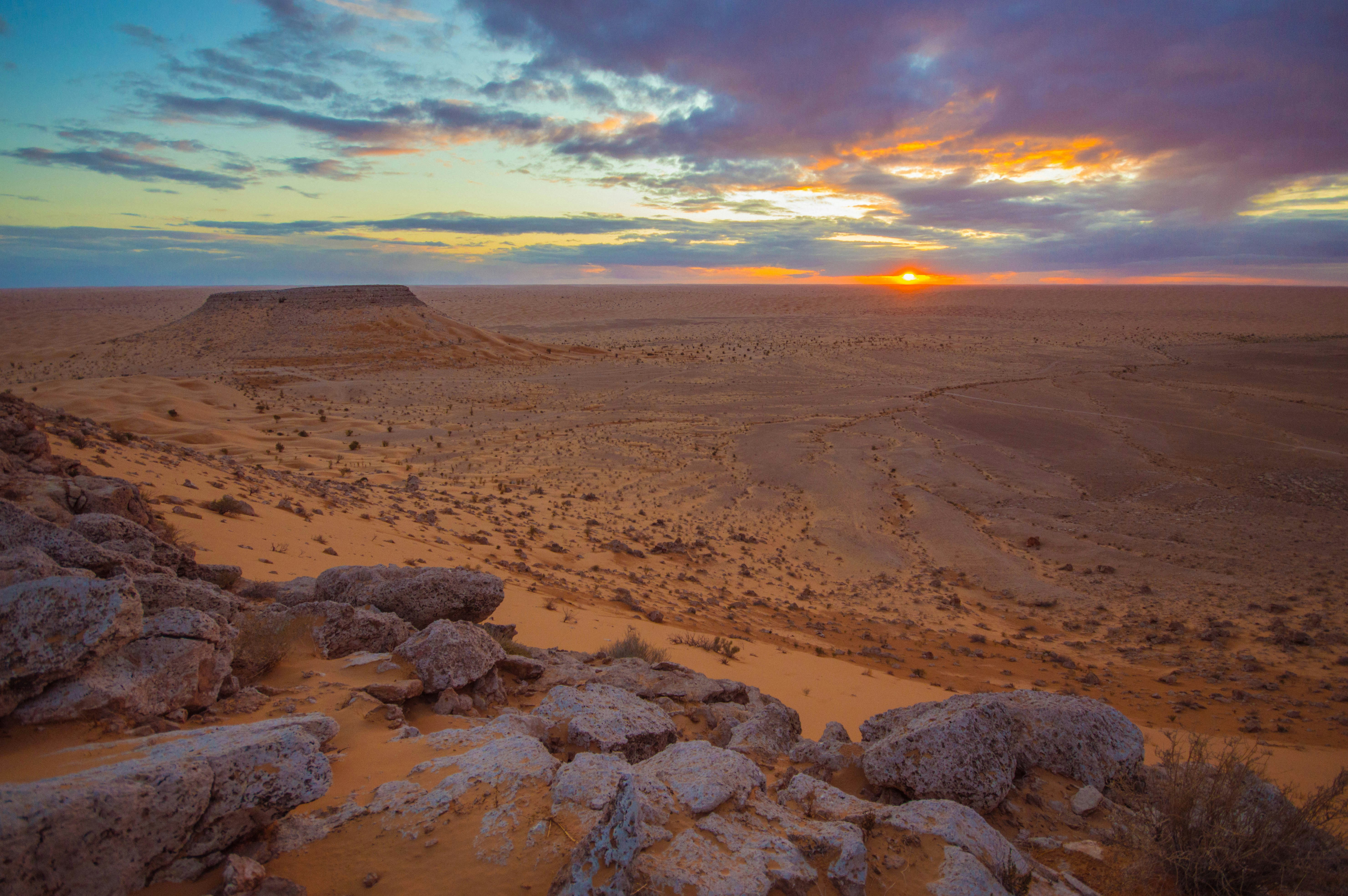brown sand under cloudy sky during sunset, 