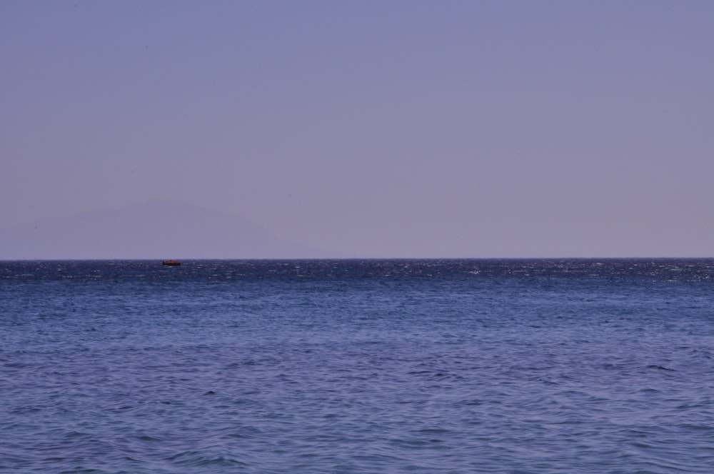 body of water under gray sky