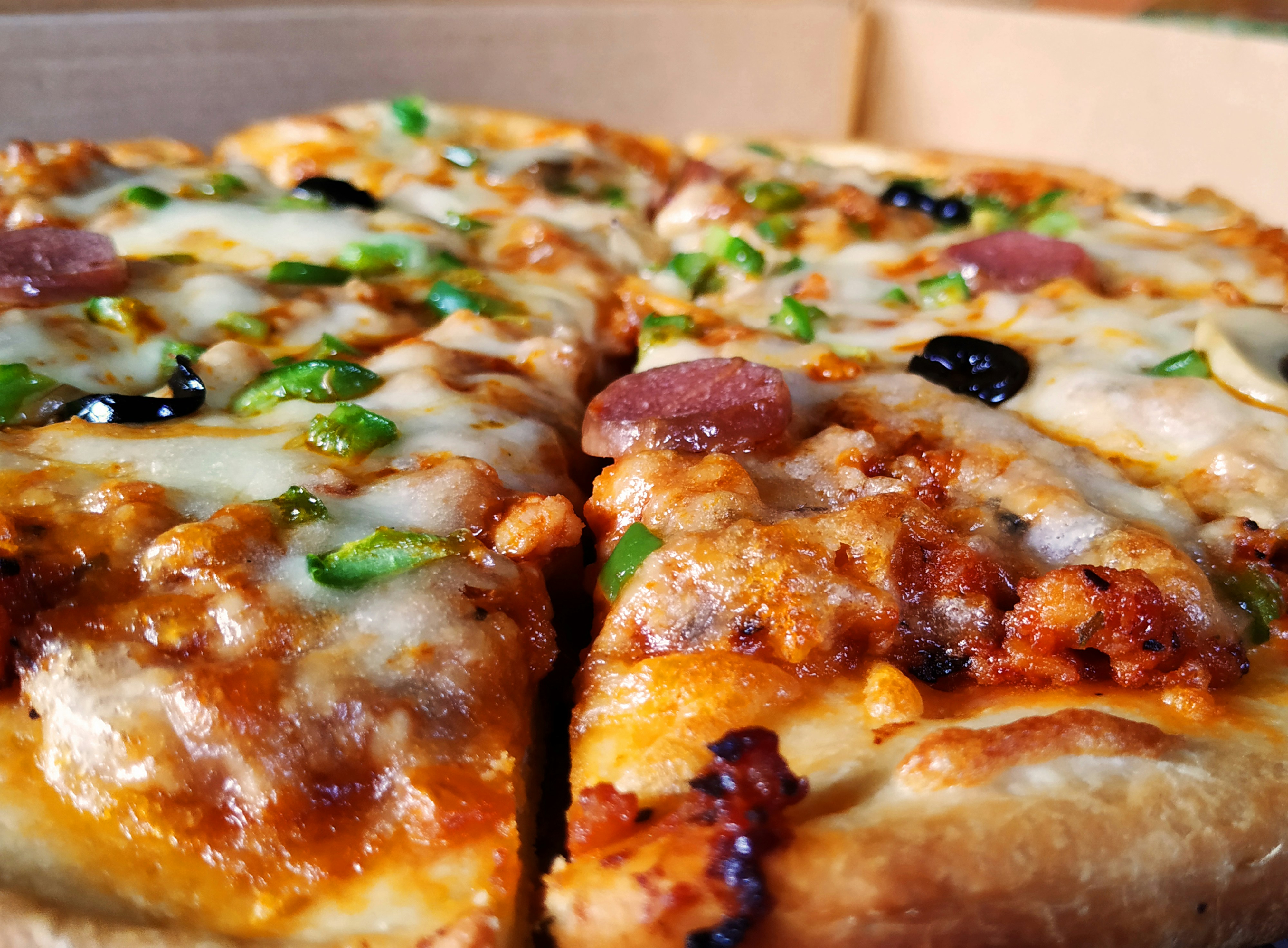 Slice of pizza with melted cheese and fresh toppings overhead view