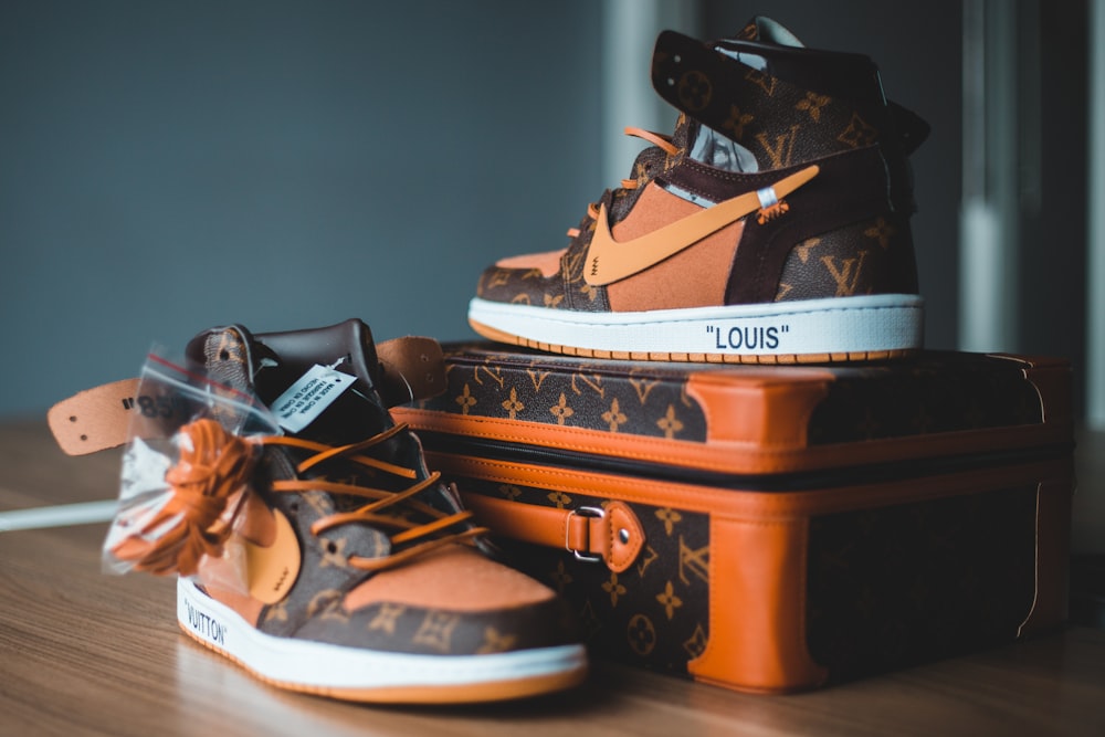 A pair of louis vuitton shoes sitting on top of luggage photo – Free  Clothing Image on Unsplash