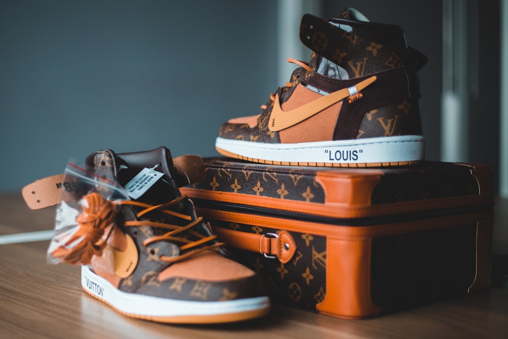 A pair of louis vuitton shoes sitting on top of luggage photo