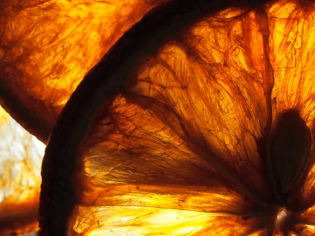 Close-up of fresh orange slices with juice droplets glistening in natural light.
