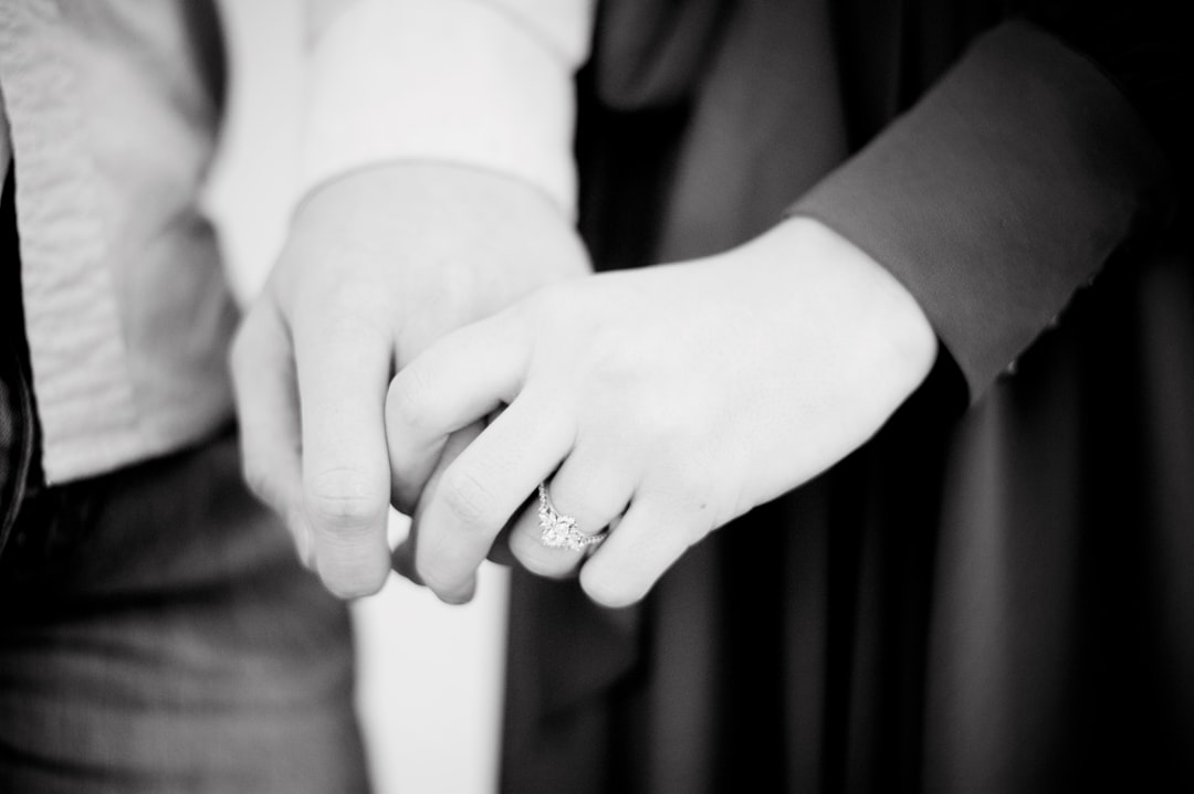 grayscale photo of person wearing ring