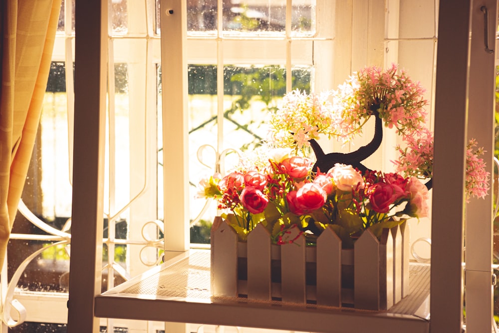 red roses on white wooden table