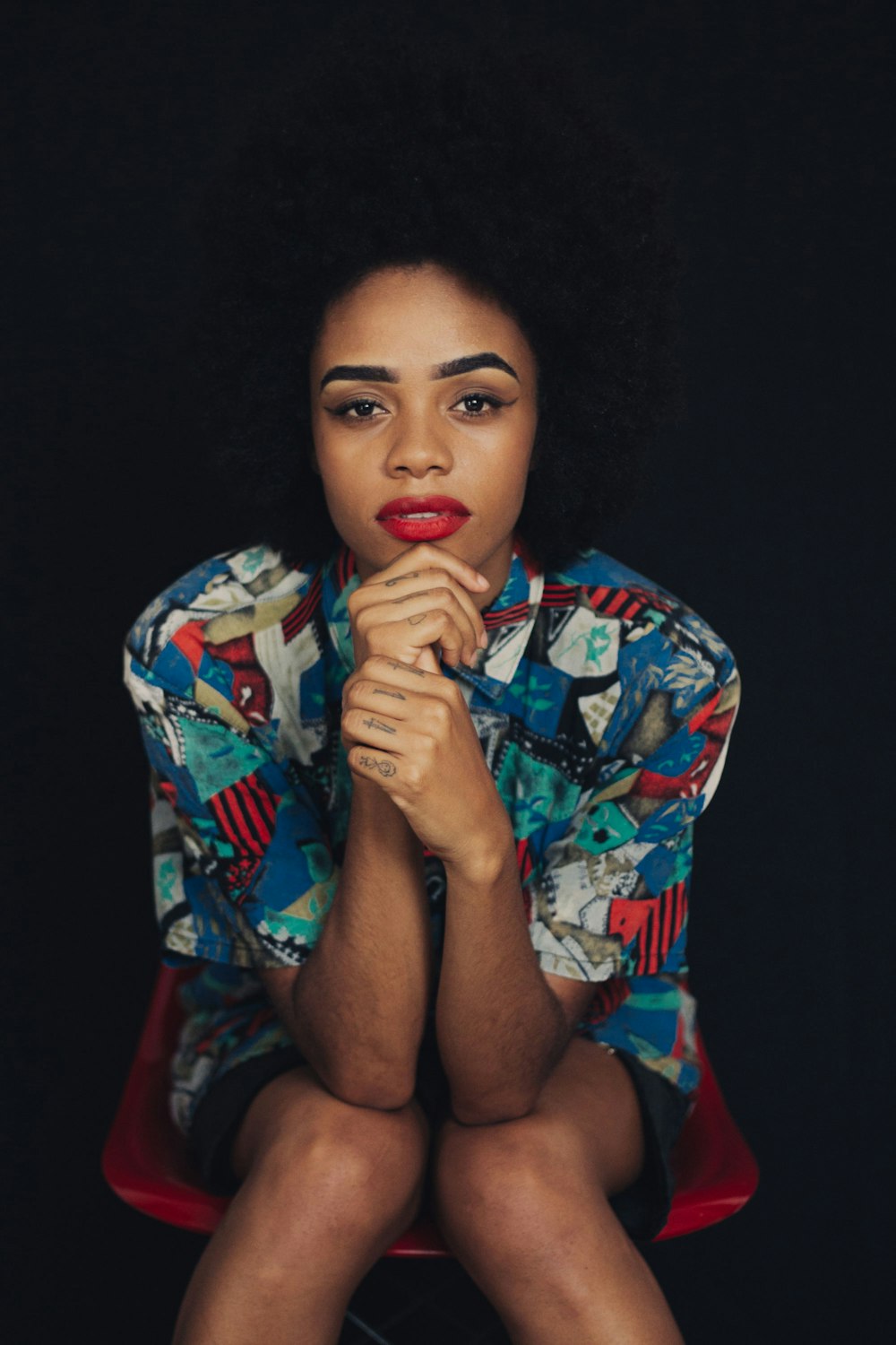 woman in white blue and red floral button up shirt